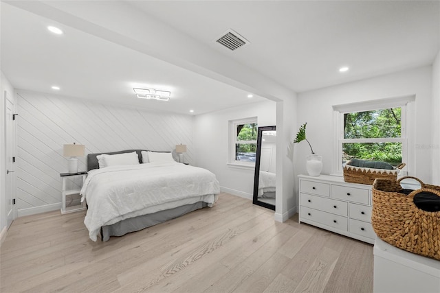 900 Oak Hollow Pl, Brandon, FL 33510 - bedroom featuring light wood-style flooring, recessed lighting, and wood walls