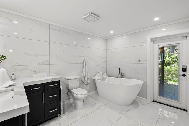 900 Oak Hollow Pl, Brandon, FL 33510 - bathroom featuring vanity, marble tiled floors, a freestanding tub, tile walls, and recessed lighting