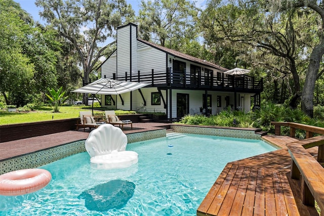 900 Oak Hollow Pl, Brandon, FL 33510 - swimming pool featuring a wooden deck and view of scattered trees