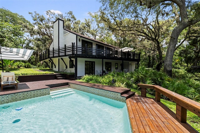 900 Oak Hollow Pl, Brandon, FL 33510 - rear view of house featuring a wooden deck, an outdoor pool, and a chimney