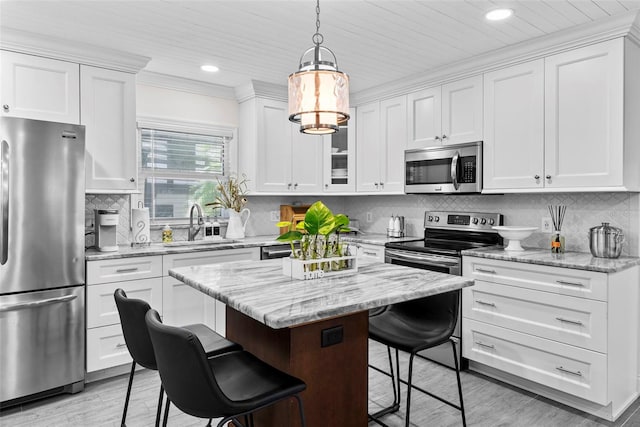 900 Oak Hollow Pl, Brandon, FL 33510 - kitchen featuring stainless steel appliances, a kitchen breakfast bar, white cabinets, recessed lighting, and a center island