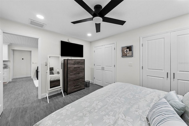 900 Oak Hollow Pl, Brandon, FL 33510 - bedroom featuring wood finished floors, two closets, recessed lighting, and a ceiling fan
