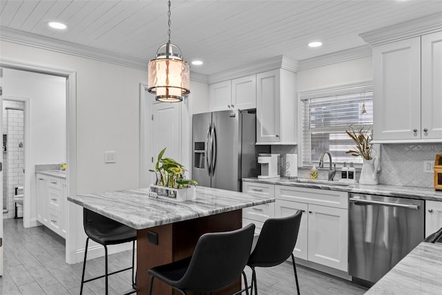 900 Oak Hollow Pl, Brandon, FL 33510 - kitchen featuring stainless steel appliances, recessed lighting, a breakfast bar area, white cabinetry, and decorative backsplash