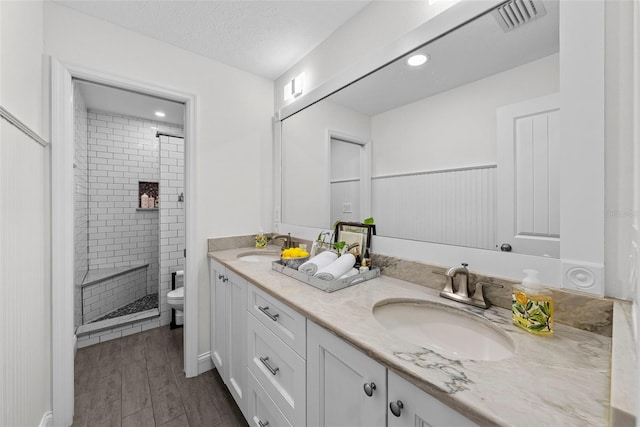 900 Oak Hollow Pl, Brandon, FL 33510 - full bathroom with double vanity, a shower stall, and wood finished floors