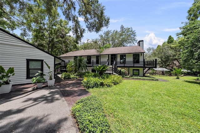 900 Oak Hollow Pl, Brandon, FL 33510 - view of front of property with a chimney, a front lawn, and stairway
