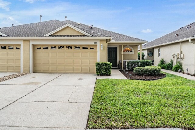 19351 Haskell Pl, Land O Lakes, FL 34638 - ranch-style house featuring driveway, roof with shingles, an attached garage, stucco siding, and a front yard