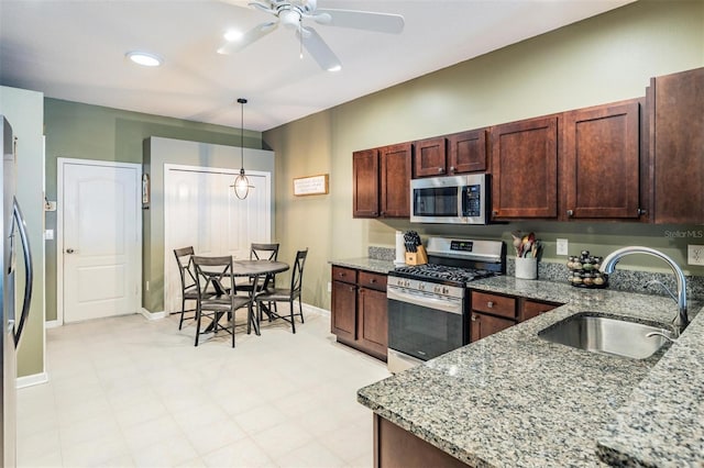 19351 Haskell Pl, Land O Lakes, FL 34638 - kitchen featuring stainless steel appliances, ceiling fan, light stone countertops, and hanging light fixtures