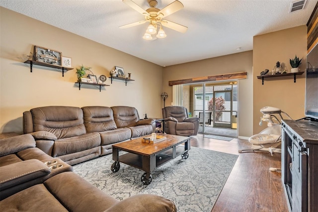 19351 Haskell Pl, Land O Lakes, FL 34638 - living room with a ceiling fan, wood finished floors, and a textured ceiling