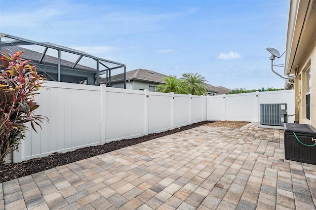 19351 Haskell Pl, Land O Lakes, FL 34638 - fenced backyard featuring a patio area and glass enclosure