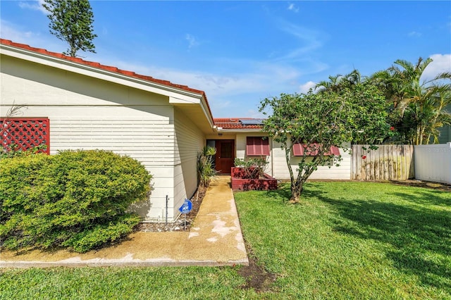 557 Crystal Dr, Madeira Beach, FL 33708 - view of exterior entry featuring solar panels