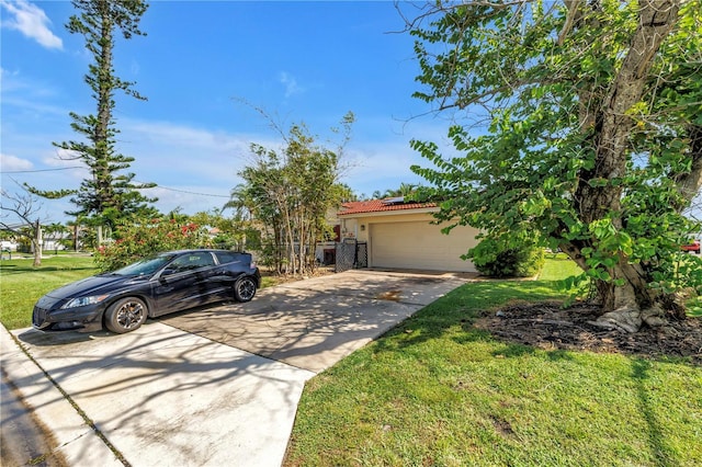 557 Crystal Dr, Madeira Beach, FL 33708 - view of front of property featuring concrete driveway, a front yard, roof mounted solar panels, a tile roof, and an attached garage