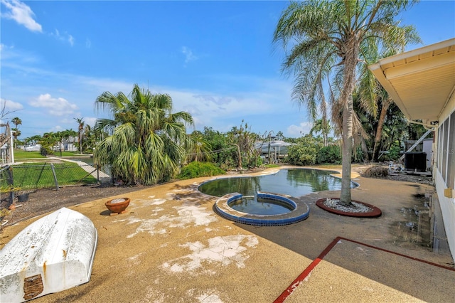 557 Crystal Dr, Madeira Beach, FL 33708 - view of pool featuring a pool with connected hot tub and a patio area