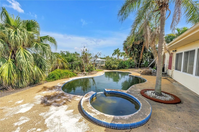 557 Crystal Dr, Madeira Beach, FL 33708 - view of swimming pool with a pool with connected hot tub and a patio