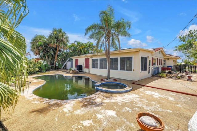 557 Crystal Dr, Madeira Beach, FL 33708 - view of pool with a pool with connected hot tub and a patio area