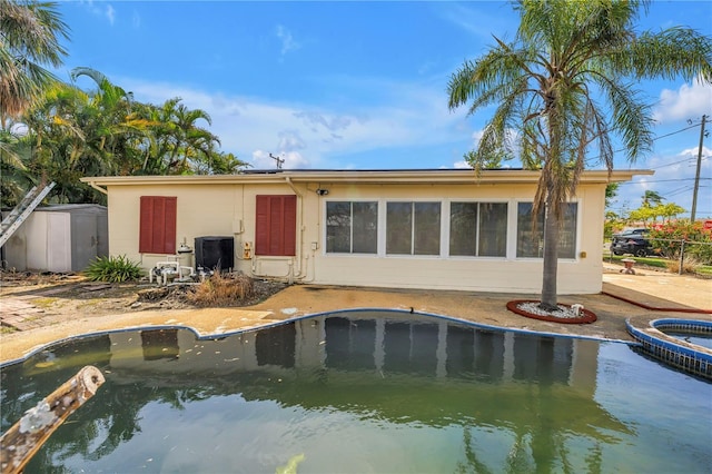 557 Crystal Dr, Madeira Beach, FL 33708 - back of property featuring a pool with connected hot tub