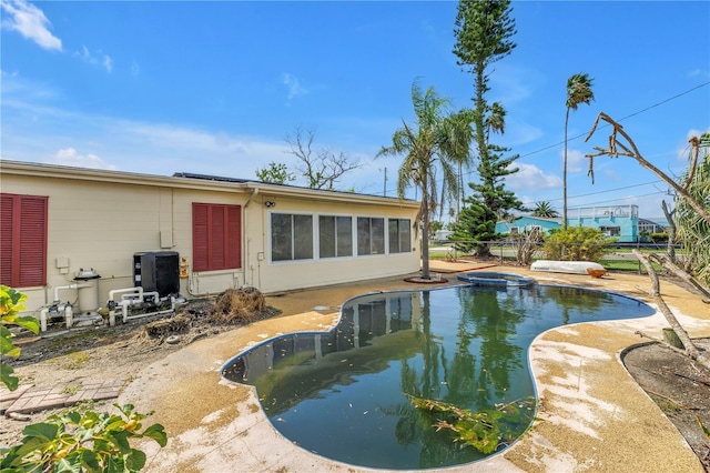 557 Crystal Dr, Madeira Beach, FL 33708 - view of swimming pool featuring a pool with connected hot tub and a sunroom
