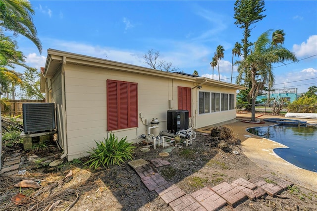 557 Crystal Dr, Madeira Beach, FL 33708 - rear view of house with a pool with connected hot tub