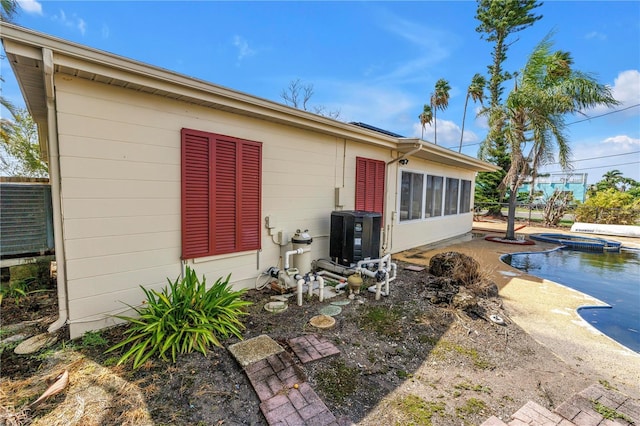 557 Crystal Dr, Madeira Beach, FL 33708 - rear view of house with a pool with connected hot tub