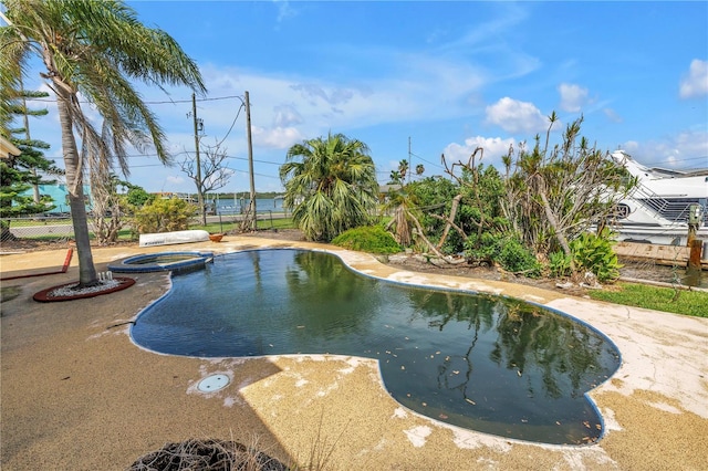 557 Crystal Dr, Madeira Beach, FL 33708 - view of swimming pool with a pool with connected hot tub and a patio