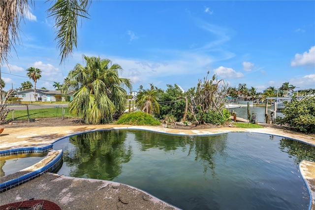 557 Crystal Dr, Madeira Beach, FL 33708 - view of swimming pool featuring a pool with connected hot tub and a dock