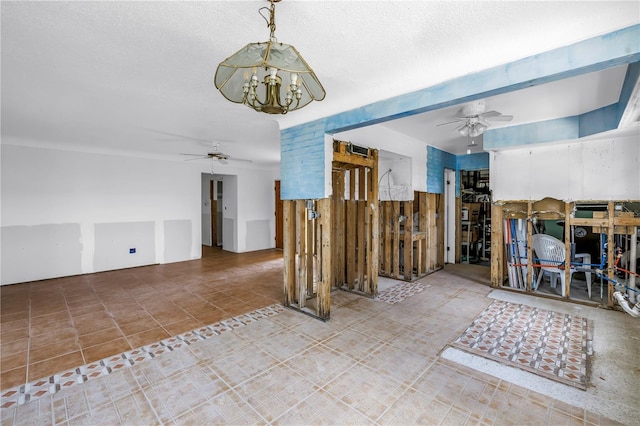 557 Crystal Dr, Madeira Beach, FL 33708 - living room featuring ceiling fan, a chandelier, tile patterned flooring, and a textured ceiling