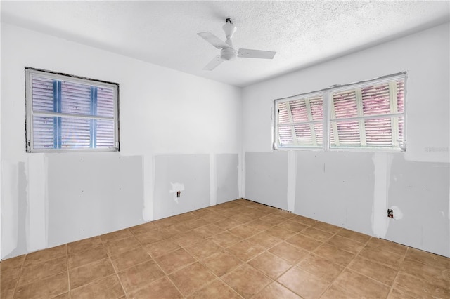 557 Crystal Dr, Madeira Beach, FL 33708 - empty room featuring ceiling fan and a textured ceiling