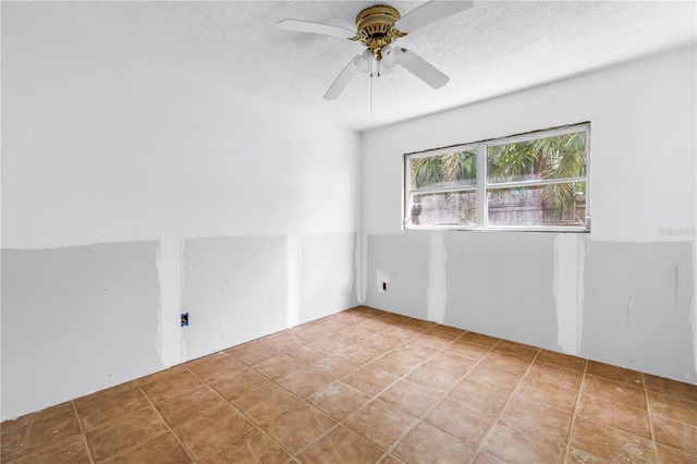 557 Crystal Dr, Madeira Beach, FL 33708 - empty room with a textured ceiling and ceiling fan