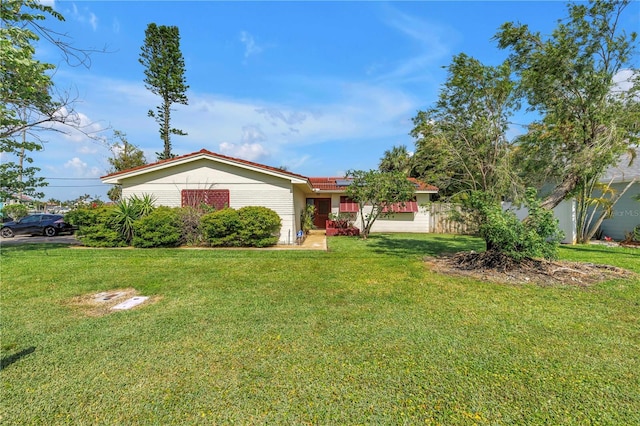 557 Crystal Dr, Madeira Beach, FL 33708 - ranch-style home with roof mounted solar panels and a front yard