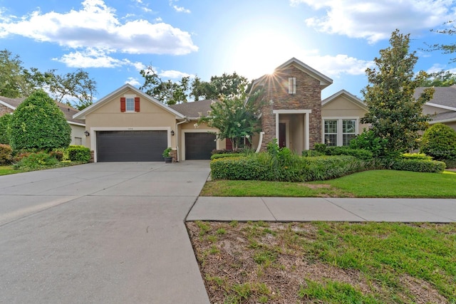 1304 Lorea Ln, Brandon, FL 33511 - traditional home featuring stone siding, an attached garage, stucco siding, concrete driveway, and a front yard