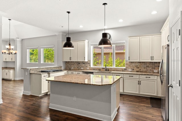 1304 Lorea Ln, Brandon, FL 33511 - kitchen with backsplash, dark wood-style floors, a kitchen island, white cabinetry, and recessed lighting