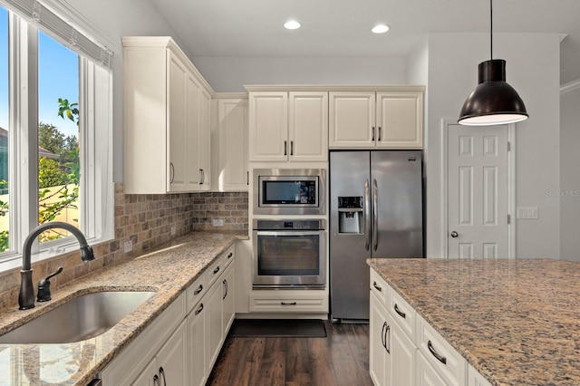 1304 Lorea Ln, Brandon, FL 33511 - kitchen featuring stainless steel appliances, dark wood-type flooring, light stone countertops, tasteful backsplash, and recessed lighting