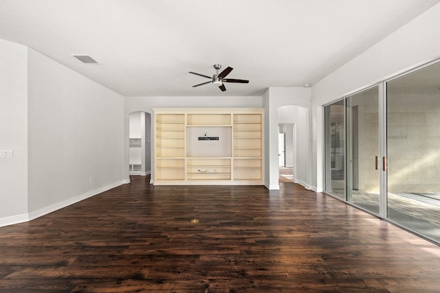 1304 Lorea Ln, Brandon, FL 33511 - unfurnished bedroom featuring arched walkways, dark wood-type flooring, two closets, and ceiling fan