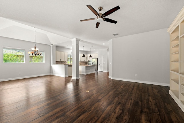 1304 Lorea Ln, Brandon, FL 33511 - unfurnished living room featuring ceiling fan, a chandelier, decorative columns, and dark wood-style flooring