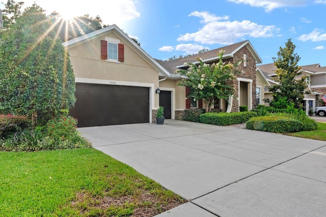 1304 Lorea Ln, Brandon, FL 33511 - view of front facade featuring stone siding, concrete driveway, stucco siding, and a front yard