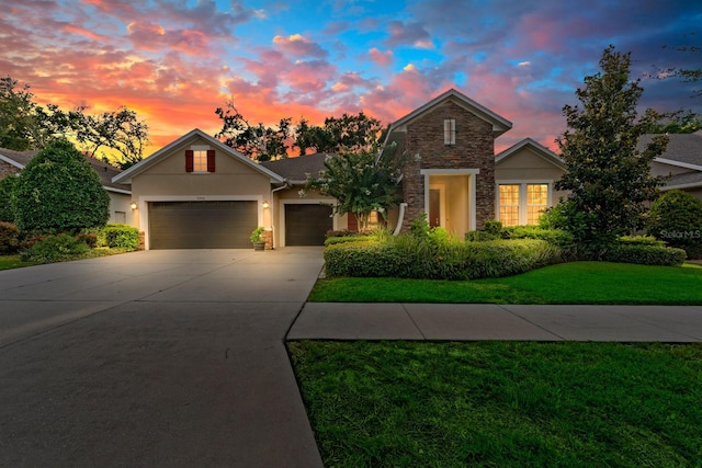 1304 Lorea Ln, Brandon, FL 33511 - traditional-style house with stone siding, stucco siding, concrete driveway, a garage, and a front yard