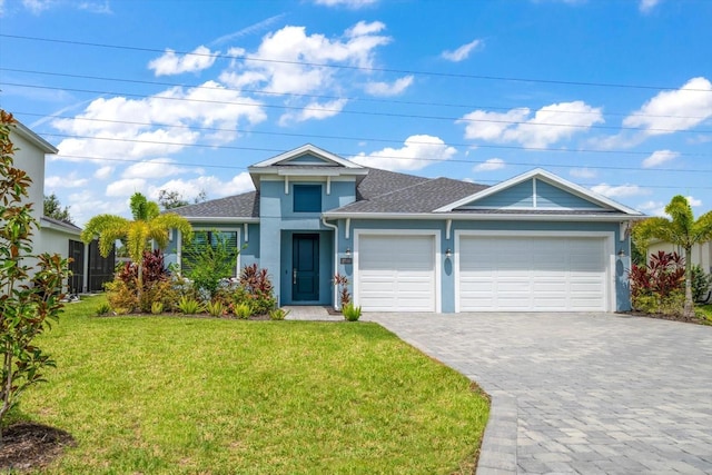 2516 Cobalt Shores Ln, Clearwater, FL 33761 - view of front of property featuring stucco siding, a front yard, an attached garage, a shingled roof, and decorative driveway