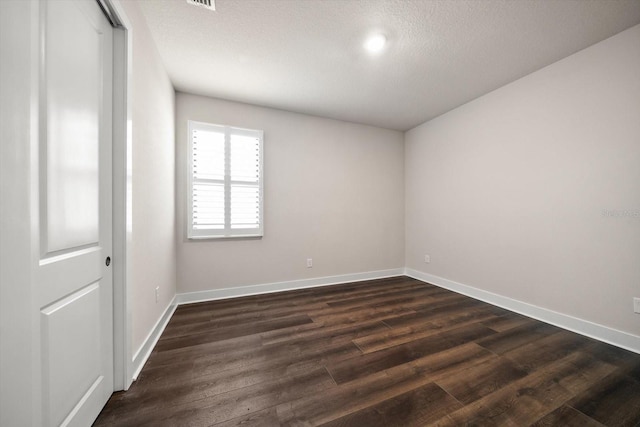 2516 Cobalt Shores Ln, Clearwater, FL 33761 - unfurnished room with dark wood finished floors and a textured ceiling