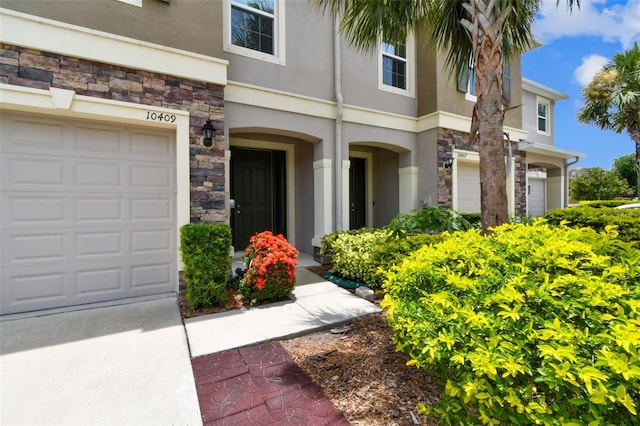 10409 Orchid Mist Ct, Riverview, FL 33578 - view of front of property with stucco siding, stone siding, and driveway
