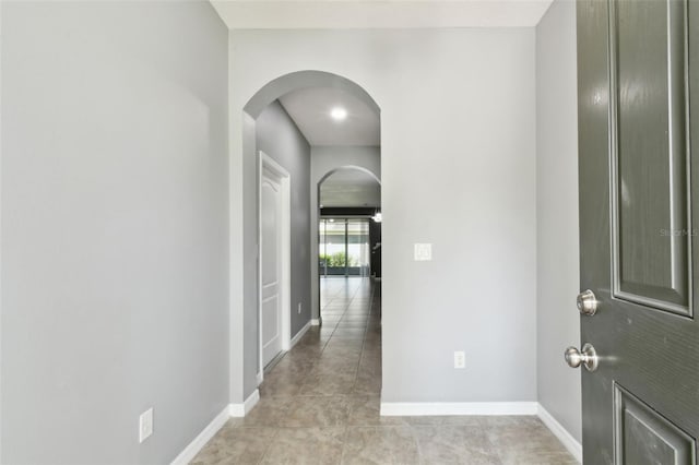 10409 Orchid Mist Ct, Riverview, FL 33578 - hall with arched walkways and light tile patterned floors