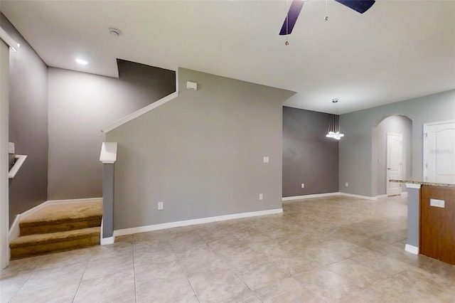 10409 Orchid Mist Ct, Riverview, FL 33578 - unfurnished living room featuring a ceiling fan, stairs, light tile patterned floors, and arched walkways
