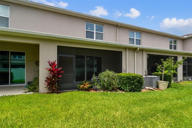 10409 Orchid Mist Ct, Riverview, FL 33578 - rear view of property with stucco siding and a yard