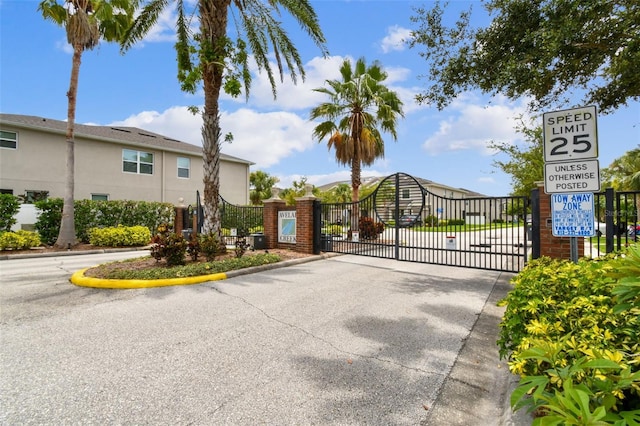 10409 Orchid Mist Ct, Riverview, FL 33578 - view of asphalt street featuring a gate, a gated entry, and curbs