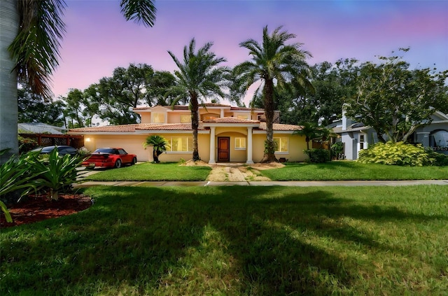 1020 Charles St, Clearwater, FL 33755 - mediterranean / spanish house with a garage, a tile roof, a front lawn, stucco siding, and driveway