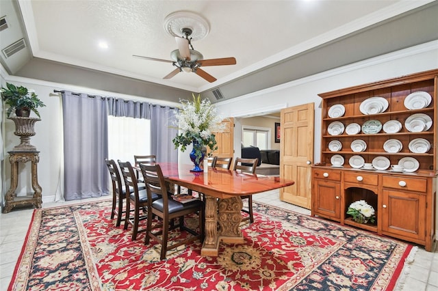 1020 Charles St, Clearwater, FL 33755 - dining room featuring healthy amount of natural light, ceiling fan, light tile patterned floors, and ornamental molding