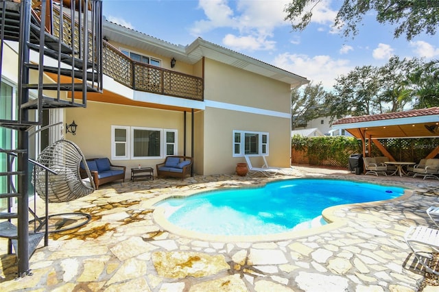1020 Charles St, Clearwater, FL 33755 - back of house with a balcony, stucco siding, and a patio