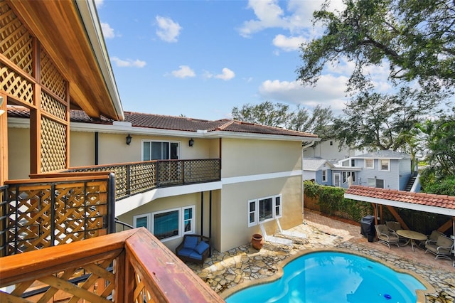 1020 Charles St, Clearwater, FL 33755 - back of property with stucco siding, a balcony, a patio, and a tile roof