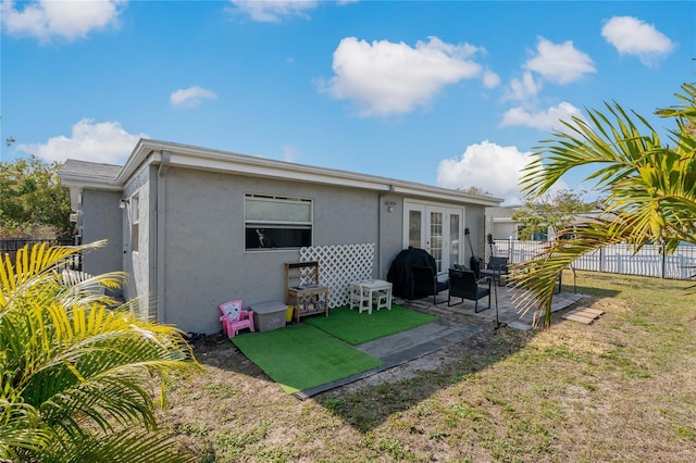 3823 Sail Dr, New Port Richey, FL 34652 - back of property with french doors, stucco siding, and a patio