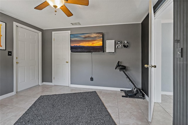 3823 Sail Dr, New Port Richey, FL 34652 - exercise room featuring ceiling fan, tile patterned flooring, and a textured ceiling