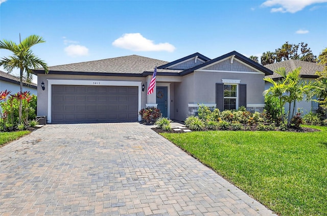 5413 Badini Way, Palmetto, FL 34221 - view of front of property featuring stucco siding, a garage, decorative driveway, and a front lawn