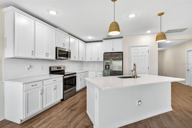 5413 Badini Way, Palmetto, FL 34221 - kitchen featuring appliances with stainless steel finishes, wood finished floors, tasteful backsplash, white cabinets, and recessed lighting